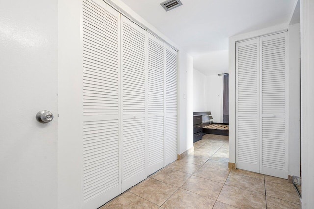 hallway featuring light tile patterned floors