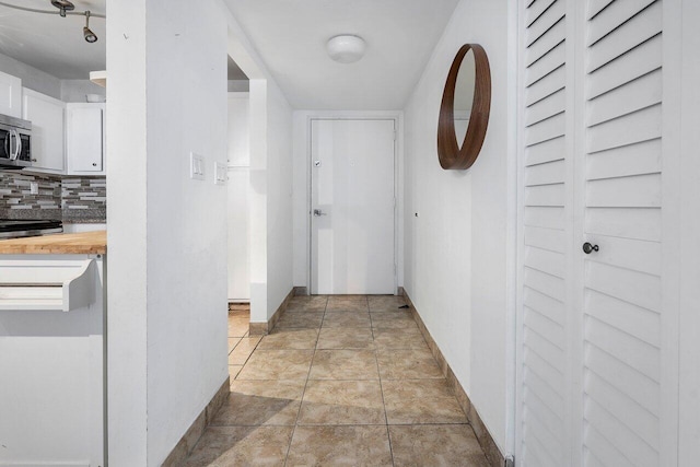 corridor with light tile patterned floors