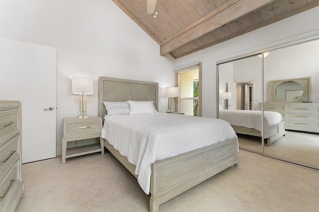 bedroom featuring lofted ceiling with beams, a closet, wooden ceiling, and ceiling fan