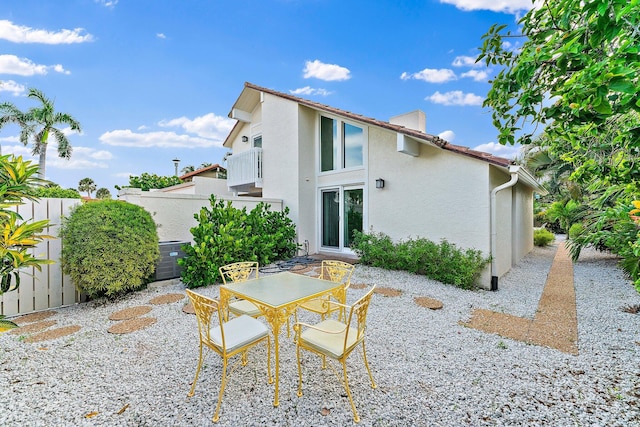 back of property featuring a patio and a balcony