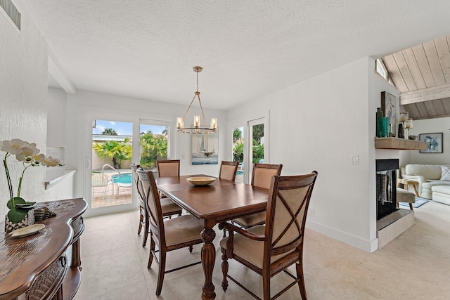 dining room with a textured ceiling, lofted ceiling, and light tile patterned flooring