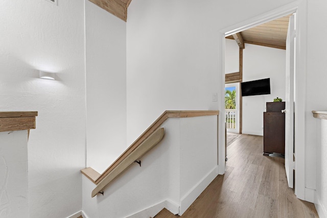 stairway featuring wood ceiling and hardwood / wood-style flooring