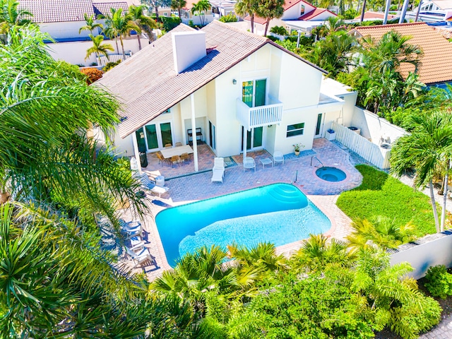 view of pool featuring an in ground hot tub and a patio