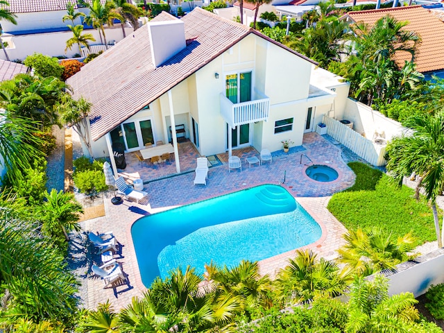 view of pool with an in ground hot tub and a patio