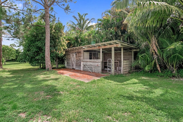 view of outdoor structure featuring a lawn