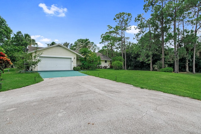 view of side of property with a yard and a garage