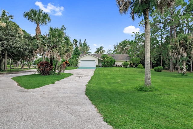 view of front facade featuring a garage and a front lawn