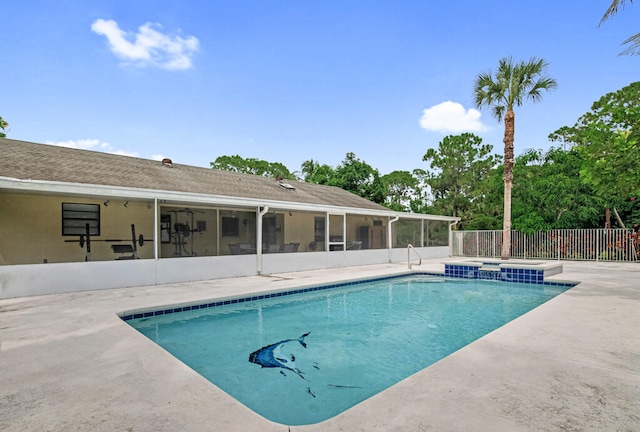 view of swimming pool with a patio and a sunroom