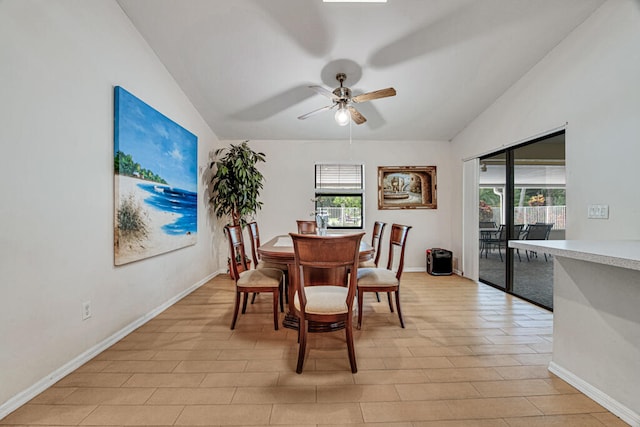 dining room featuring ceiling fan, light wood-type flooring, and vaulted ceiling