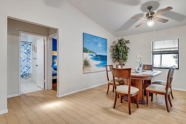 dining room with lofted ceiling, ceiling fan, and light wood-type flooring