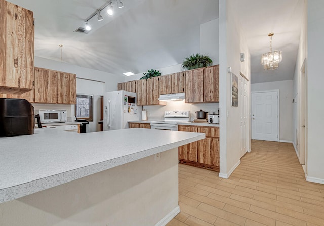 kitchen featuring white appliances, a chandelier, kitchen peninsula, hanging light fixtures, and light hardwood / wood-style floors