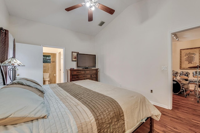 bedroom with lofted ceiling, hardwood / wood-style floors, ceiling fan, and connected bathroom