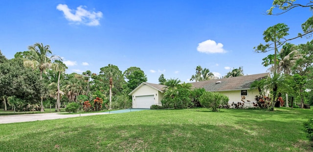 view of front of home with a garage and a front lawn