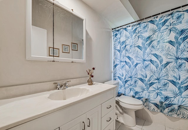 bathroom featuring tile patterned flooring, toilet, and vanity