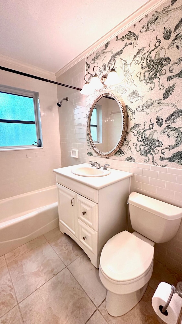 full bathroom with toilet, ornamental molding, vanity, tiled shower / bath, and tile walls