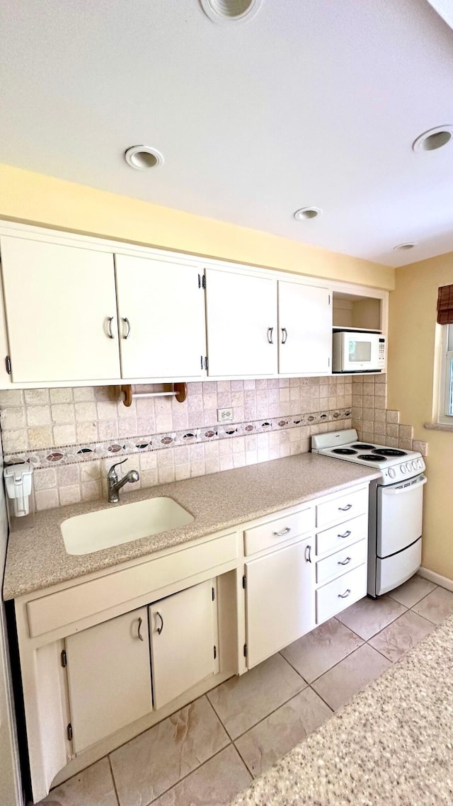 414 Seasage Dr Unit 3, Delray Beach, FL 33483 - kitchen featuring light countertops, light tile patterned floors, a sink, white appliances, and decorative backsplash