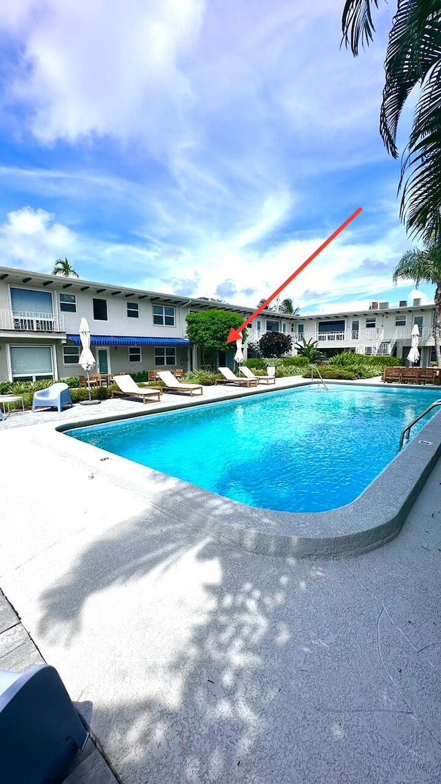 view of swimming pool featuring a grill and a patio