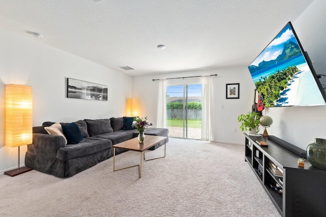 carpeted living room featuring a textured ceiling