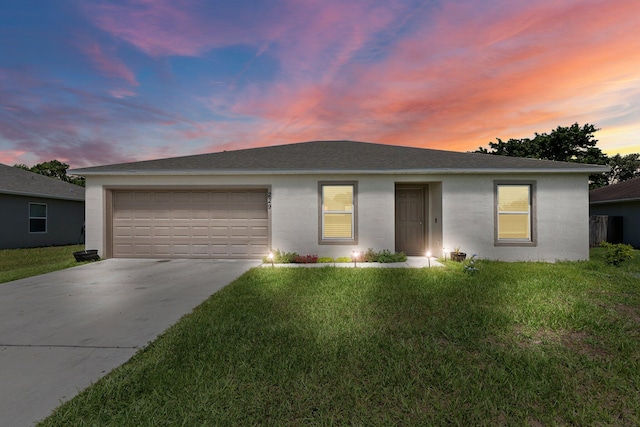 ranch-style home with a lawn and a garage