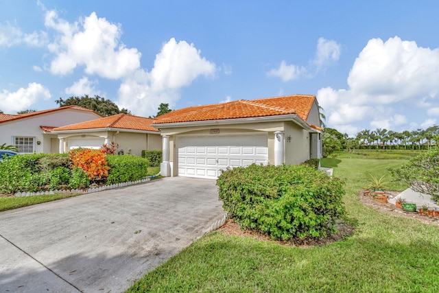 view of front of house with a front yard and a garage