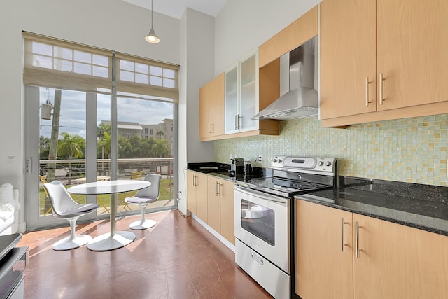 kitchen featuring pendant lighting, stainless steel electric stove, light brown cabinets, and wall chimney range hood