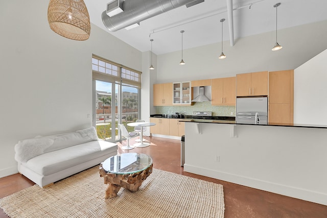 living room featuring a high ceiling and concrete flooring