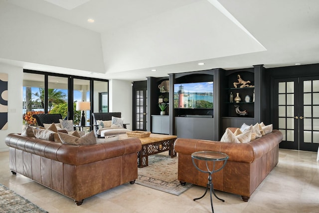 living room featuring a towering ceiling and french doors