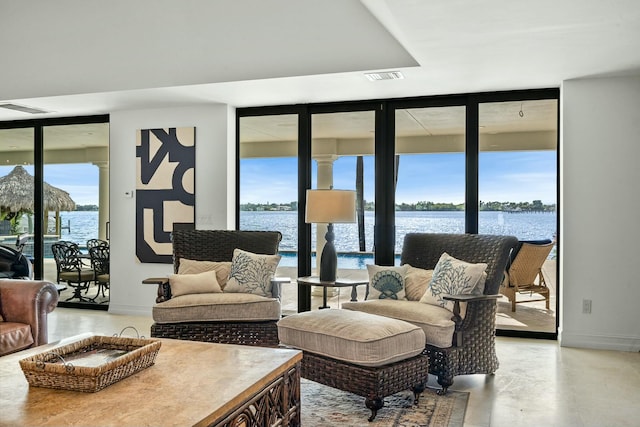 living room with plenty of natural light and a water view