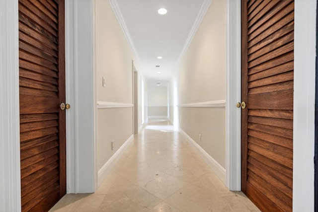 corridor with ornamental molding, recessed lighting, and baseboards