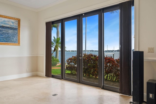 unfurnished room with a water view, crown molding, and baseboards