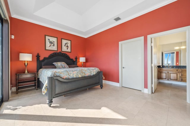 bedroom with baseboards, visible vents, a raised ceiling, ornamental molding, and ensuite bathroom