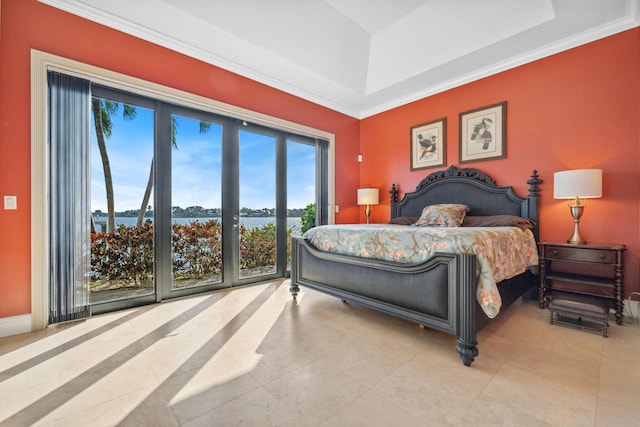 bedroom with a water view, access to exterior, baseboards, and a tray ceiling