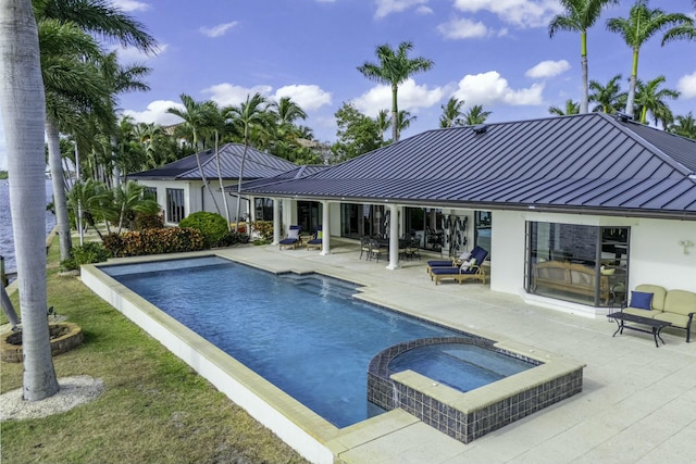 view of swimming pool with a patio area and a pool with connected hot tub