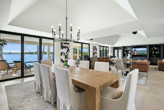 dining room with expansive windows, a water view, and plenty of natural light