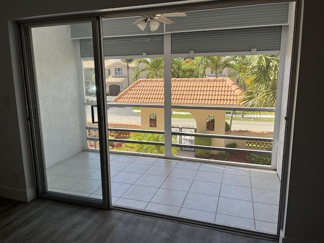 doorway to outside with ceiling fan and dark hardwood / wood-style floors