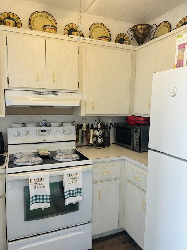 kitchen featuring light brown cabinetry, white appliances, and dark hardwood / wood-style flooring