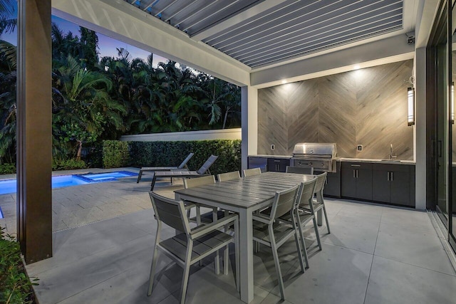 view of patio / terrace with outdoor dining space, area for grilling, a sink, and a fenced in pool