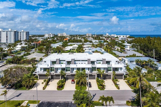 birds eye view of property with a water view and a city view