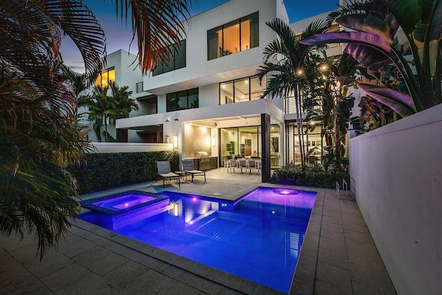 view of swimming pool with a pool with connected hot tub and a patio area