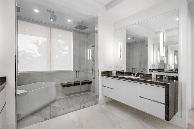 full bath featuring a freestanding bath, a stall shower, vanity, and recessed lighting