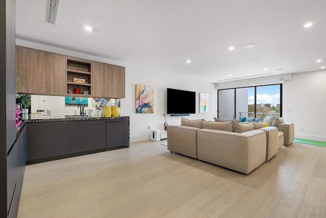 living room with light wood-style floors, recessed lighting, visible vents, and baseboards