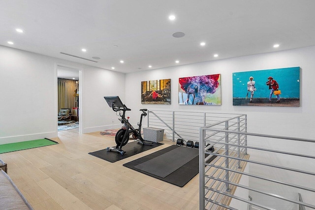 workout area with recessed lighting, baseboards, and wood finished floors