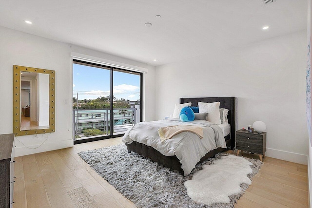 bedroom featuring hardwood / wood-style flooring, access to outside, and recessed lighting