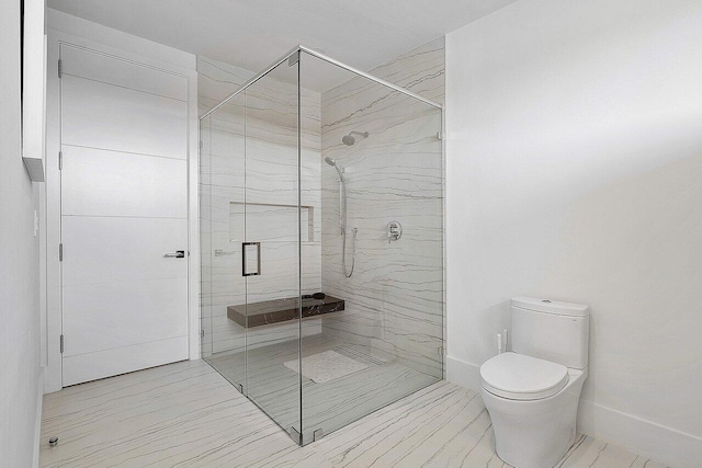 full bathroom with a marble finish shower, baseboards, marble finish floor, and toilet