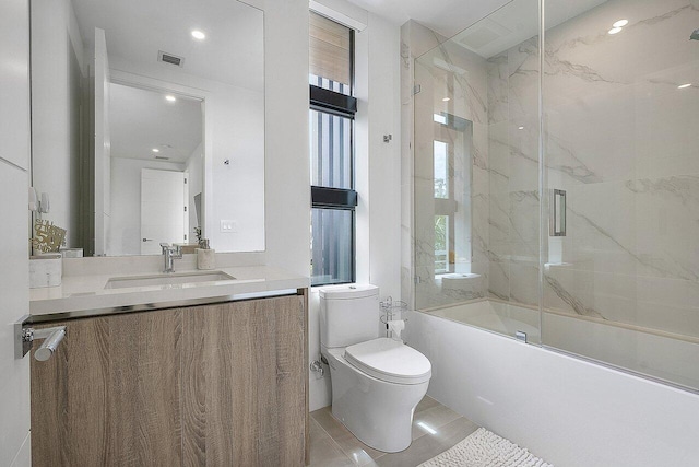 bathroom featuring toilet, enclosed tub / shower combo, visible vents, and a wealth of natural light