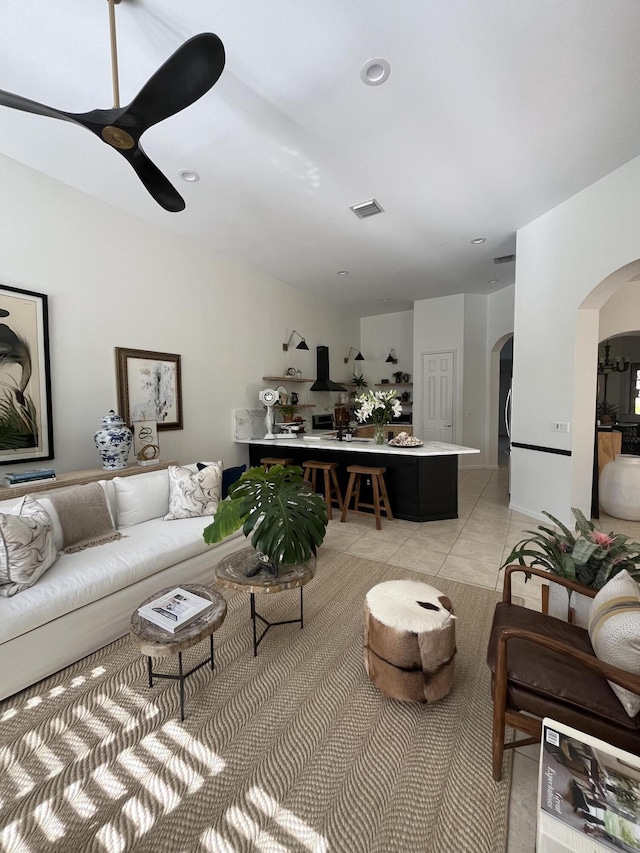 tiled living room featuring ceiling fan