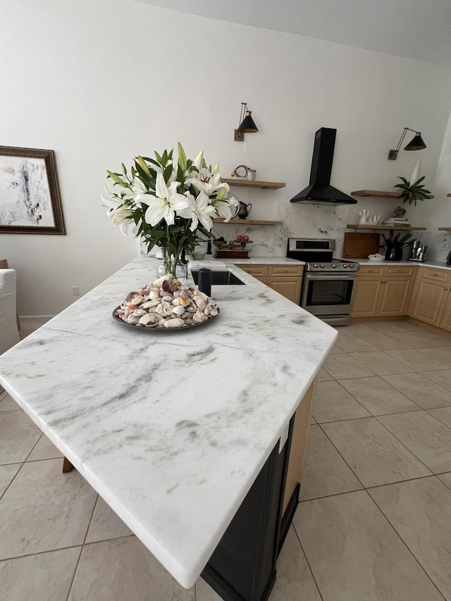 kitchen with stainless steel range, light tile patterned floors, a center island, and extractor fan