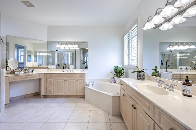 bathroom with tile patterned floors, vanity, and shower with separate bathtub