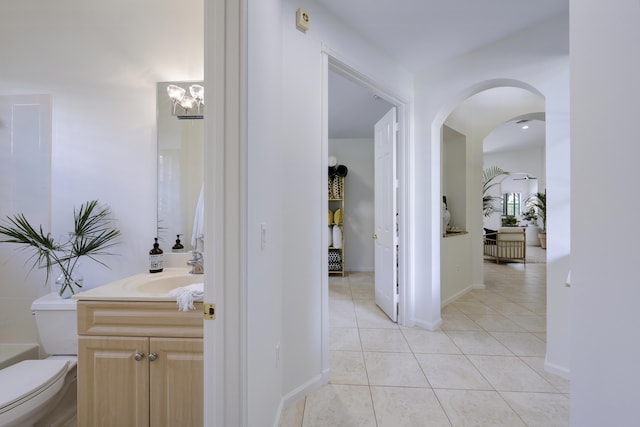 bathroom featuring tile patterned flooring, vanity, and toilet