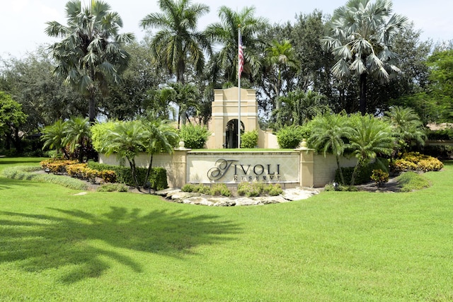 community / neighborhood sign with a yard